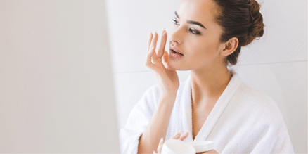 applying lotion to face