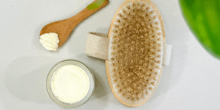 Dry brush with tallow and a wooden applicator spoon