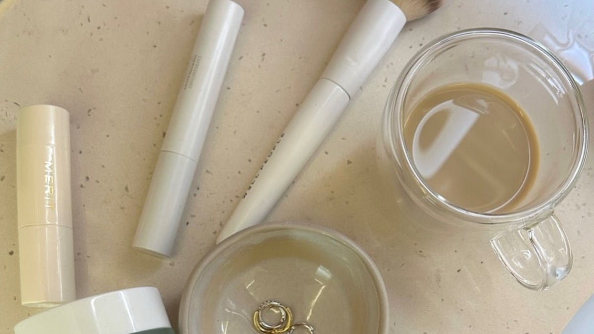 Best tallow face cream: Ageless Cloud Cream, tallow lip balms and a makeup brush on a vanity counter