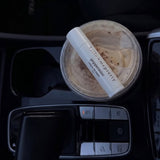 Best tallow lip balm: Peppermint tallow lip balm resting on an iced coffee in a car cup holder