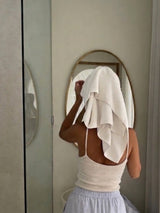 AM and PM tallow skincare routine: woman drying her face with a towel in front of a round mirror