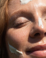 Beef tallow for dry skin and wrinkles: close up of a woman's face with dabs of tallow cream on her nose and cheek