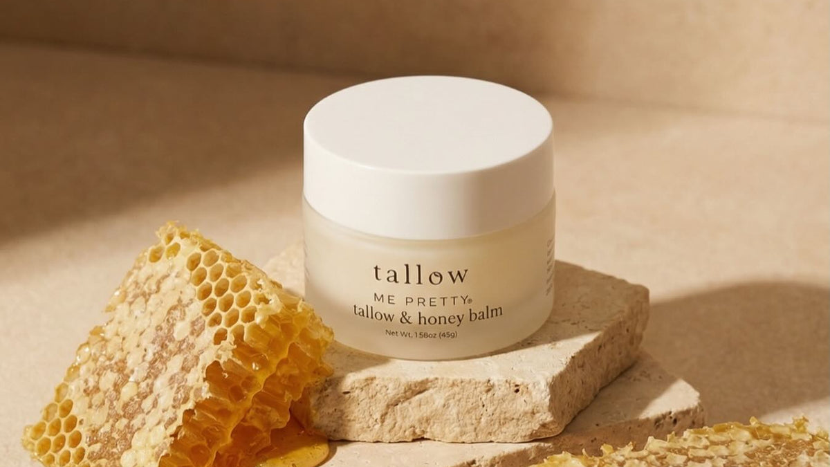 Grass fed tallow for skin: Tallow and Honey Balm jar on stone with fresh honeycomb