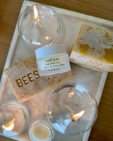 Neptune Tallow and honey balm reviews: Tallow and Honey Balm on a tray with beeswax bars and candles