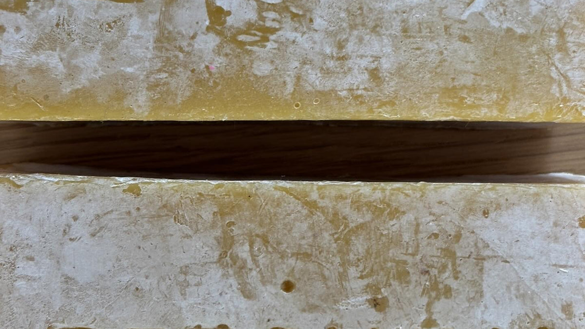 Beef tallow, beeswax and honey: close up of stamped organic beeswax blocks