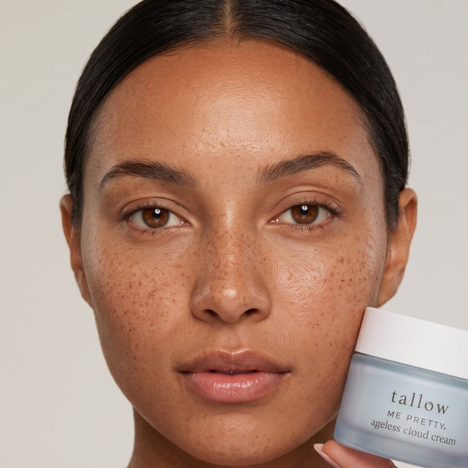 Tallow face cream: woman with freckles holding Ageless Cloud Cream beside her face