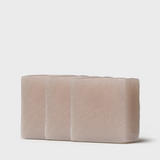 Three aligned bars of gentle tallow soap, in a soft, pale beige tone, displaying a smooth, hand-cut finish that hints at the soap's creamy and moisturizing qualities.