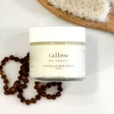Serene spa-like setting with Tallow Me Pretty's Gentle Cloud Cream, flanked by natural wooden beads and a soft sponge, inviting a moment of tranquility and pure care with its gentle, nourishing formula.