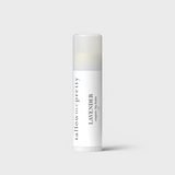 An elegant lavender organic lip balm stick by Tallow Me Pretty, featuring a crisp white label with minimalist black typography, providing a soothing, natural lip care option.