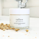 Jar of Tallow Me Pretty's Gentle Cloud Cream placed on a bathroom counter, accompanied by dried chamomile flowers, symbolizing the cream's gentle, organic ingredients safe for soothing baby skin and providing natural care.