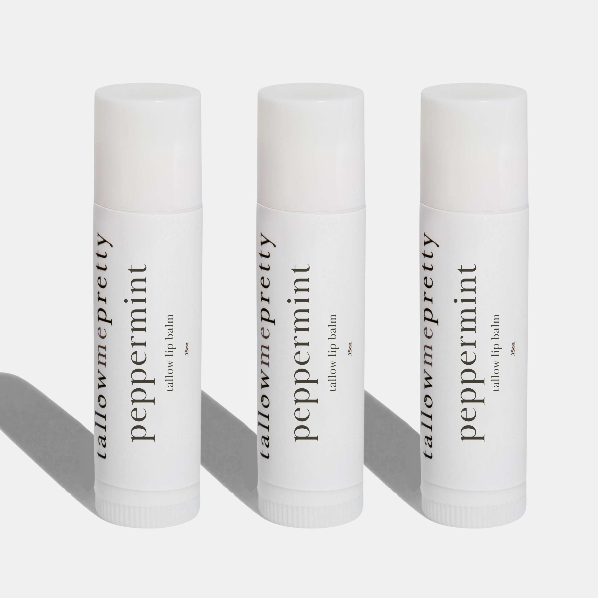 Three tallow me pretty peppermint lip balms on a white background