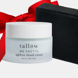 Tallow Me Pretty ageless cloud cream jar with a black box and red ribbon on a white background