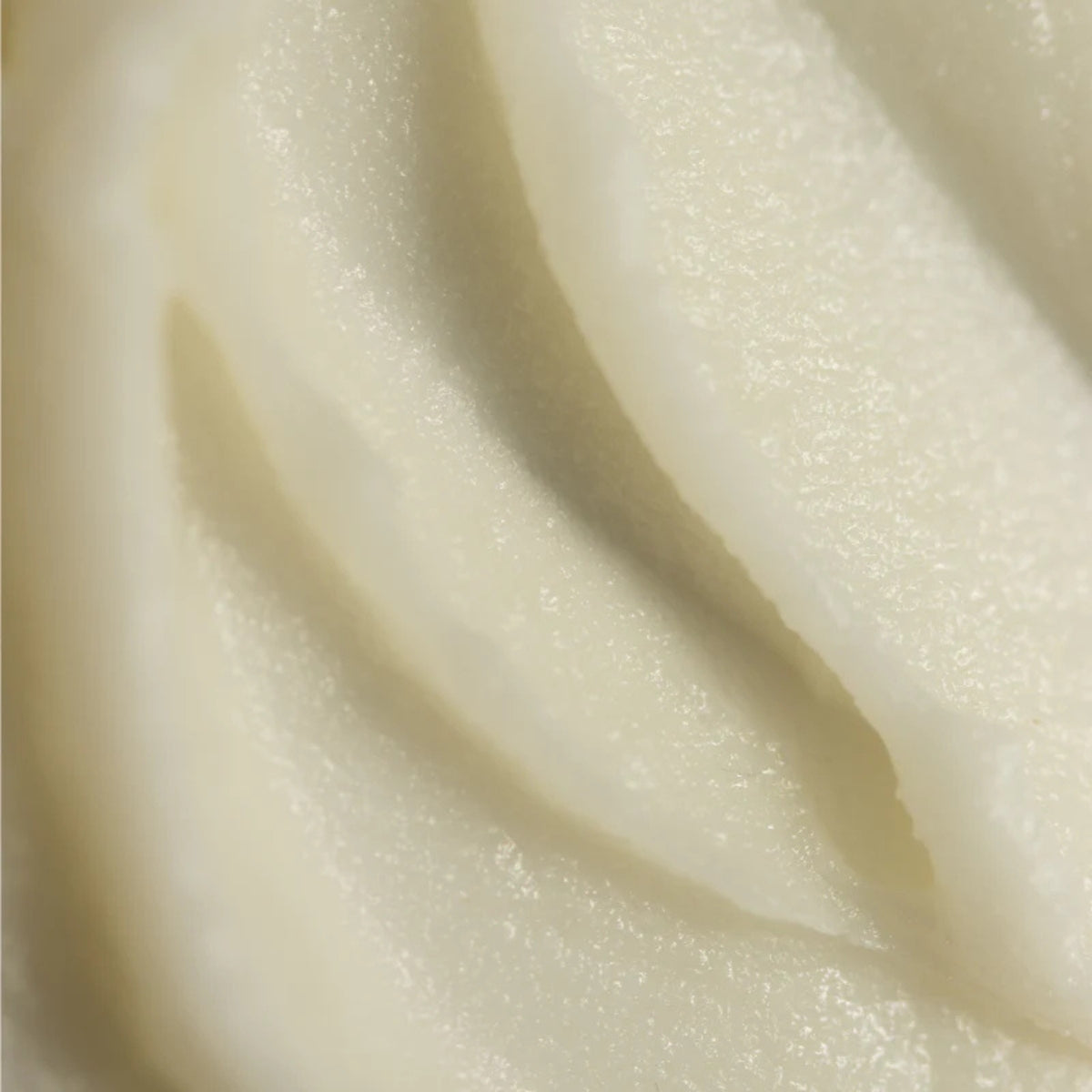 Close-up of smooth, beige fabric texture of tallow and honey balm.