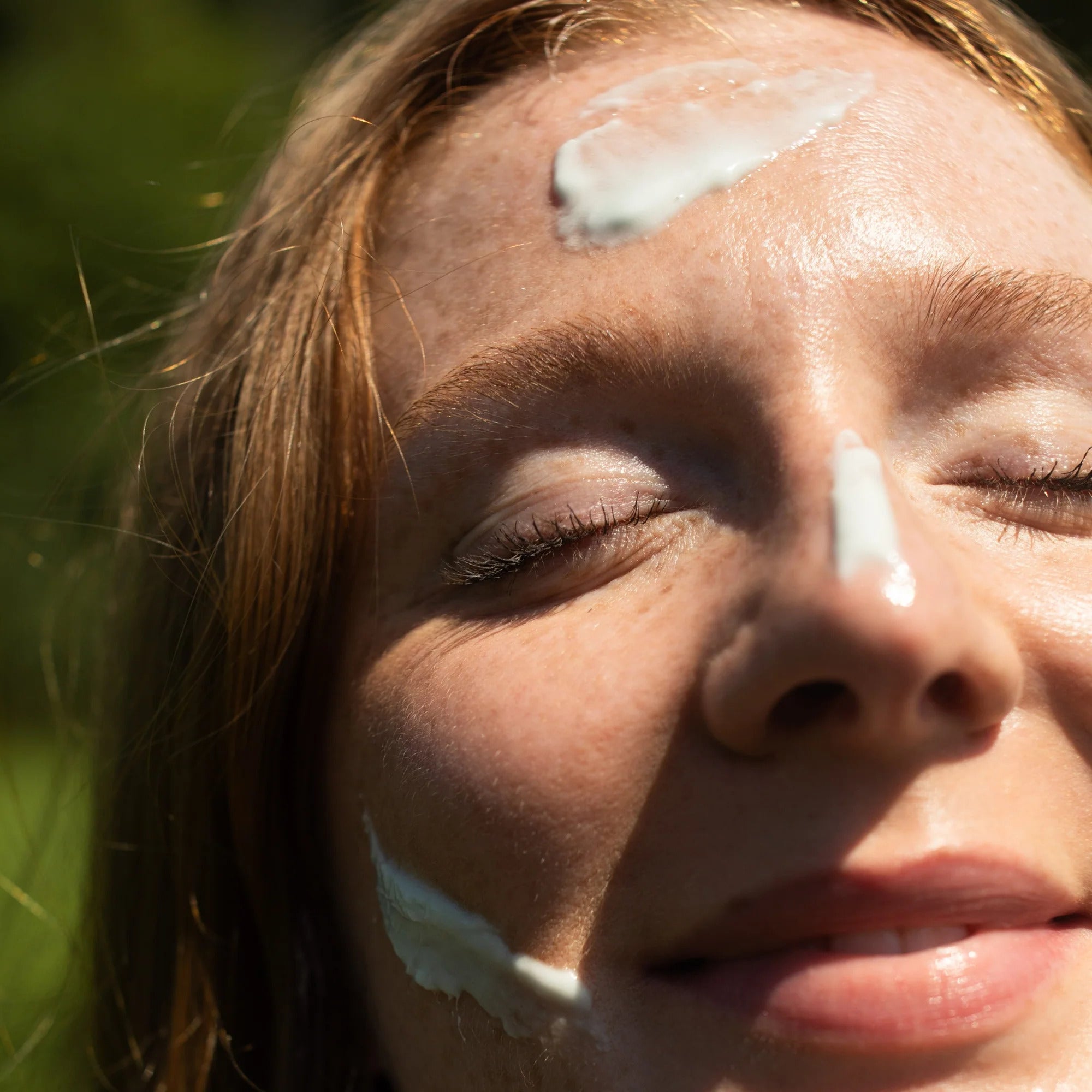 Close-up of a person with unscented cloud cream on their face outdoors