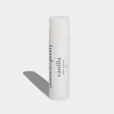 White lip balm stick with 'tallowe & pretty' branding on a light gray background