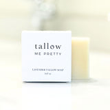 A neatly packaged Lavender Tallow Soap from 'Tallow Me Pretty' in a white box with clear, elegant black typography, placed against a soft-focus background with a pale yellow tallow bar visible to the side.