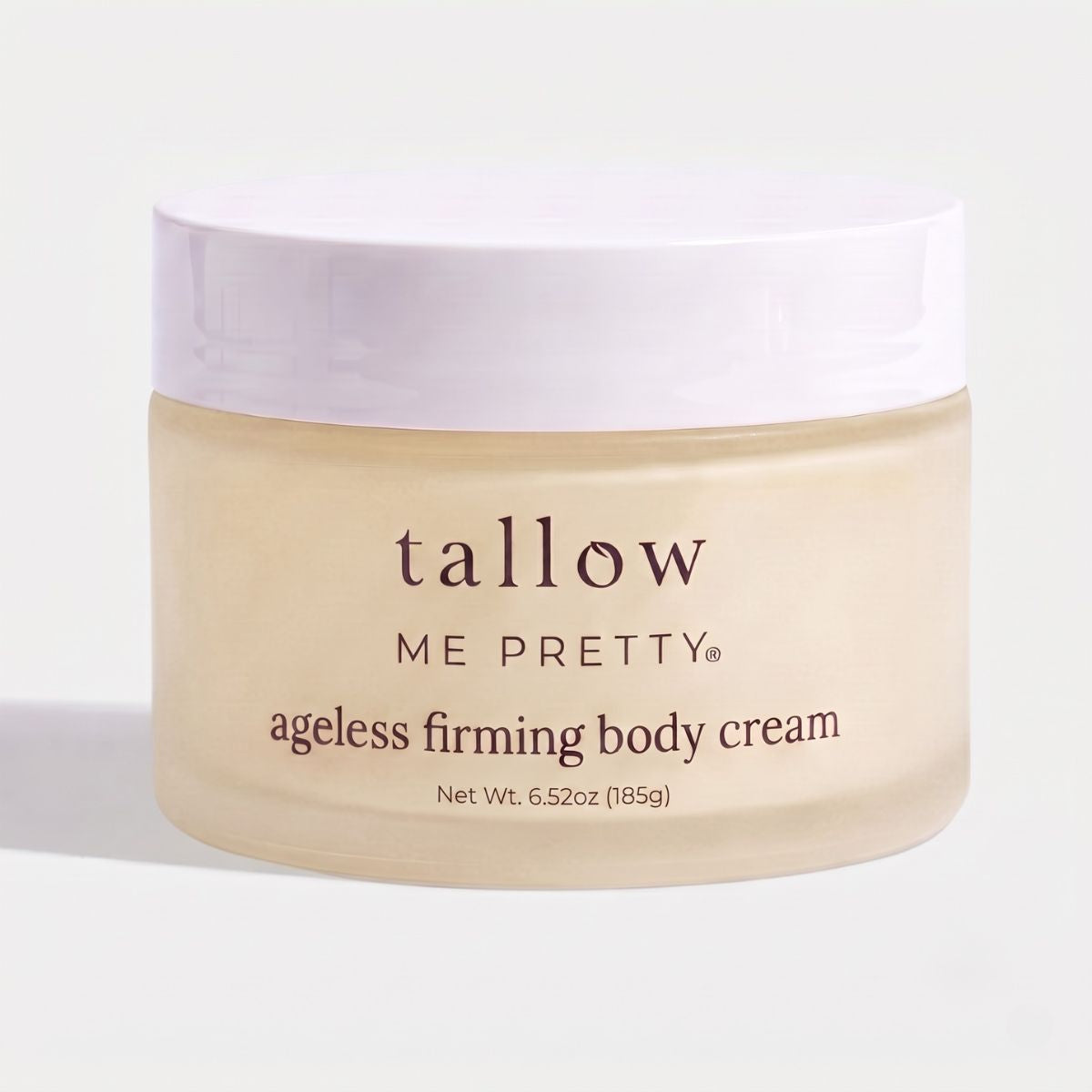 A jar of Tallow Me Pretty Ageless Firming Body Cream on a clean white background. The jar is a frosted pale beige color with a white lid, featuring dark brown text.