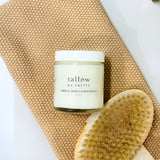 Firming Body Cloud Cream is displayed on an earthy knitted towel with a spa dry brush.