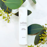 Tallow Me Pretty Herbal Chest Rub positioned amongst fresh eucalyptus leaves, symbolizing the natural, botanical ingredients used for soothing respiratory relief in a convenient stick format.