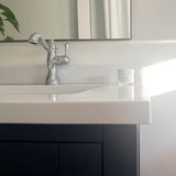 Sleek Tallow Me Pretty Anti-Aging Cloud Cream strategically placed on a pristine white bathroom countertop beside a classic faucet, bathed in natural sunlight, epitomizing the daily luxury skincare ritual.