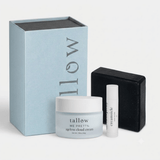 A skincare gift set featuring a large light blue box with vertical 'tallow' branding, a frosted white jar of Me Pretty Ageless Cloud Cream, a small white lip balm tube labeled 'creamsicle', and a black rectangular box, all arranged on a clean white background.